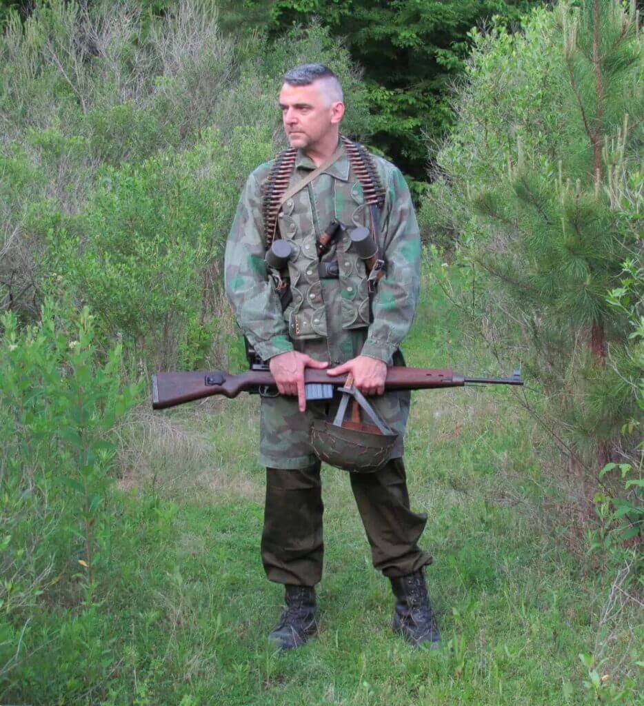 Veteran in camo holding his gear